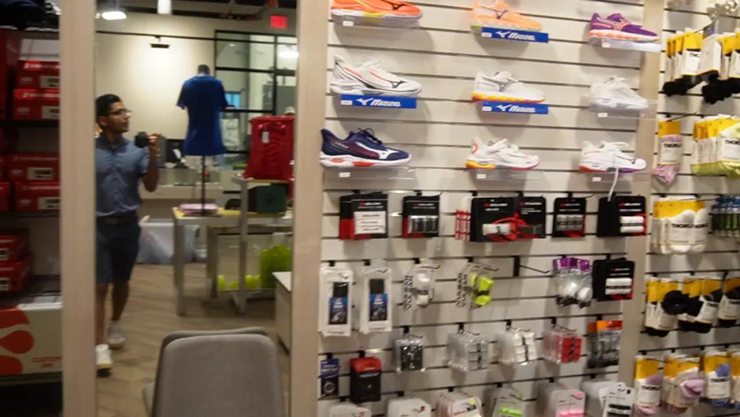 The equipment store wall of paddles, balls and shoes
